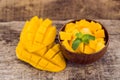 Mango fruit and mango cubes on the wooden table Royalty Free Stock Photo