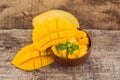 Mango fruit and mango cubes on the wooden table Royalty Free Stock Photo