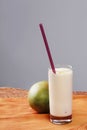 Mango fruit and glass of cold lassi drink on the table