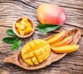 Mango fruit and mango cubes on the wood. Royalty Free Stock Photo