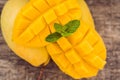 Mango fruit and mango cubes on the wooden table Royalty Free Stock Photo