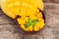 Mango fruit and mango cubes on the wooden table Royalty Free Stock Photo