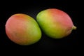 Mango of green and red color on a black background closeup Royalty Free Stock Photo