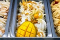 Mango ice cream with physalis. Various ice creams in trays in the ice cream shop top view