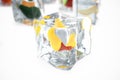 Mango in ice cube isolated on white with depth of field effects. Ice cubes with fresh berries. Berries fruits frozen in