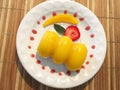 Mango jelly dessert with a slice of fresh strawberry Royalty Free Stock Photo