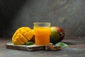 mango juice with Fresh tropical fruit on a dark background. Detox and healthy superfoods concept