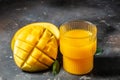 mango juice with Fresh tropical fruit on a dark background. Detox and healthy superfoods concept