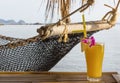 Mango juice next to net hammock Royalty Free Stock Photo