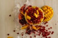 Mango juice and pomegranate seeds served in disposable glass isolated on table top view of healthy drink Royalty Free Stock Photo