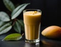 Mango lassi, a healthy smoothie with mango and yogurt, on a dark background.