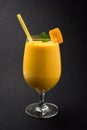 Mango Lassi or smoothie in big glass with mint leaf. Side angle Isolated over colourful background Royalty Free Stock Photo