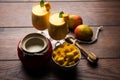 Mango Lassi or smoothie in big glass or small bottles with curd, cut fruit pieces and blender. Royalty Free Stock Photo