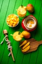 Mango Lassi or smoothie in big glass or small bottles with curd, cut fruit pieces and blender. Royalty Free Stock Photo