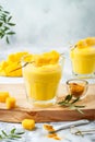 Mango Lassi, yogurt or smoothie with turmeric. Healthy probiotic Indian cold summer drink.