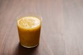Mango lulo smoothie on walnut wood table with copy space Royalty Free Stock Photo