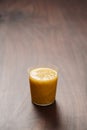 Mango lulo smoothie on walnut wood table with copy space Royalty Free Stock Photo