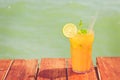 Mango mojito on the wooden pier. Concept of luxury tropical vacation. Classic cocktail