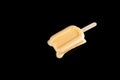 Mango or orange flavor popsicle in a melting process on black Royalty Free Stock Photo