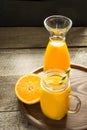 Mango and orange juice and slice of orange on wooden table. Fresh healthy drink. Close up. Royalty Free Stock Photo