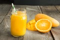 Mango and orange juice and slice of orange on wooden table. Fresh healthy drink. Royalty Free Stock Photo