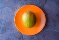 Mango is on the orange plate Royalty Free Stock Photo