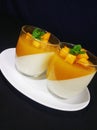Mango pannacota on white plating Royalty Free Stock Photo