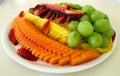 Mango papaya pineapple plump kiwi and grapes plate Royalty Free Stock Photo