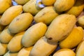 Mango, a photo of fresh yellow mango pile on market table. Ripe tropical fruit closeup.