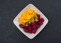 Mango pieces and raspberries with passion fruit in a white bowl Royalty Free Stock Photo