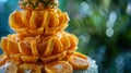 Mango and pineapple intricately carved into a layered tower creating a stunning and unique presentation Royalty Free Stock Photo
