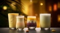 Mango, pistachio, almond, blackberry and coconut lassis with decoration and a cozy blur background