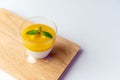 Mango pudding on wooden board with white background