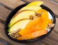 Mango slices and baked pumpkin with yogurt, cereals, nuts