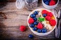 Mango smoothie bowl with raspberries, blueberries, chia seeds and almonds Royalty Free Stock Photo