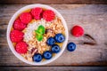 Mango smoothie bowl with raspberries, blueberries, granola and coconut Royalty Free Stock Photo