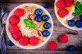 Mango smoothie bowl with raspberries, blueberries, granola and coconut Royalty Free Stock Photo