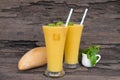 Mango smoothies juice and fruit mango from the wood background