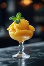 Mango sorbet in a glass on the table . Popsicle in a glass