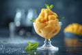 Mango sorbet in a glass on the table . Popsicle in a glass