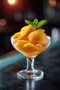 Mango sorbet in a glass on the table . Popsicle in a glass