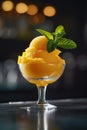 Mango sorbet in a glass on the table . Popsicle in a glass