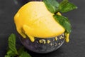 Mango sorbet, summerish dessert in a scoop decorated with mint l Royalty Free Stock Photo