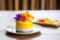 mango sticky rice with edible flower decoration