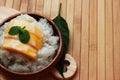 Mango sticky rice is put in a wooden container placed on a brown Royalty Free Stock Photo