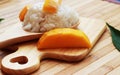 Mango sticky rice is put in a wooden container placed on a brown Royalty Free Stock Photo