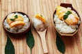 Mango sticky rice is put in a wooden container placed on a brown Royalty Free Stock Photo