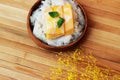 Mango sticky rice is put in a wooden container placed on a brown Royalty Free Stock Photo