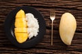 Mango sticky rice still life on wooden background