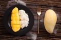 Mango sticky rice still life on wooden background